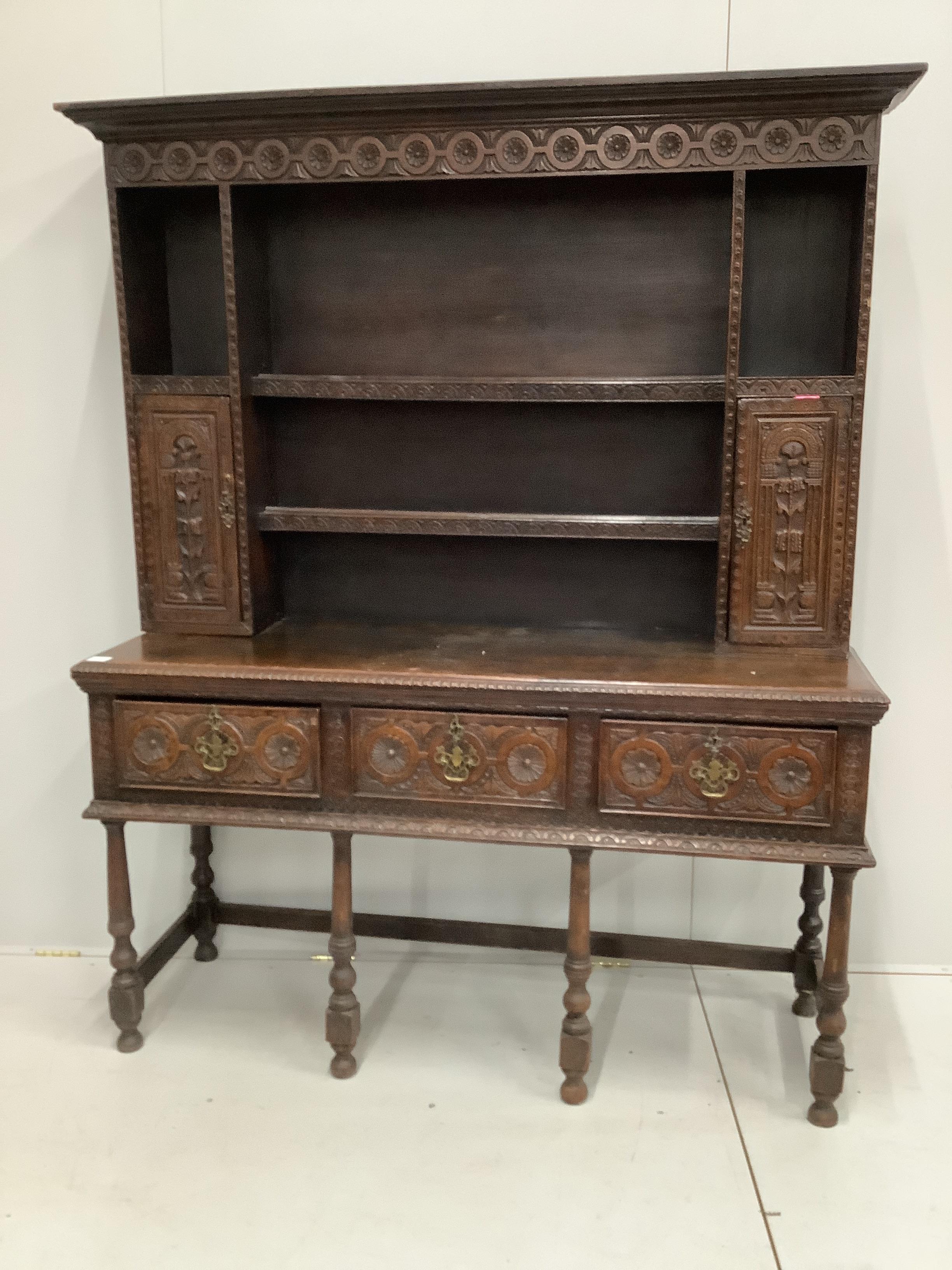 An 18th century style carved oak dresser, width 151cm, depth 49cm, height 191cm